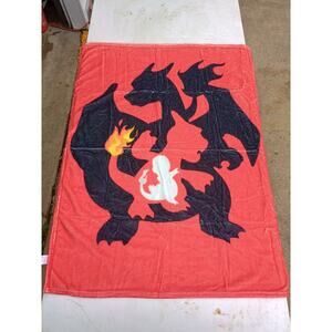 red mini blanket featuring the Pokémon Charizard and its pre-evolutions.
